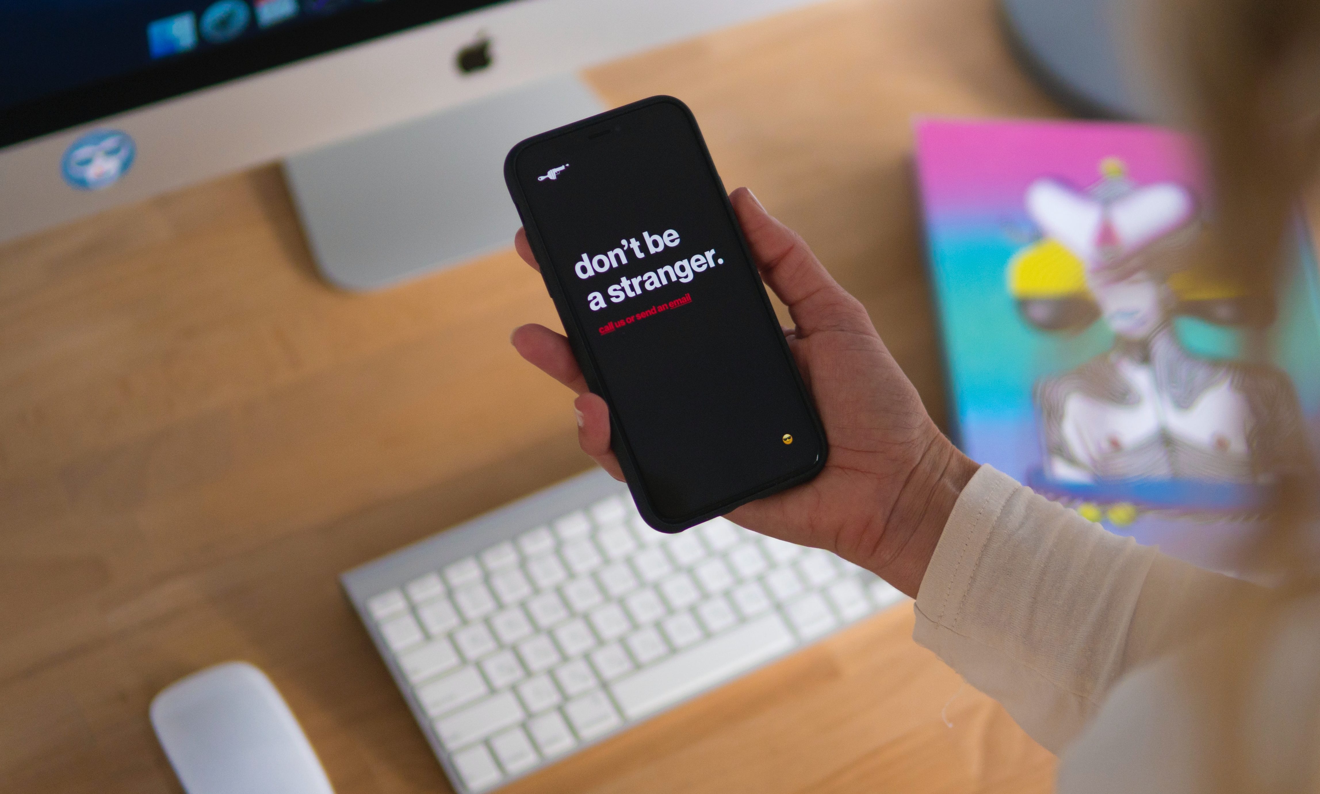 Hand holding iphone with text