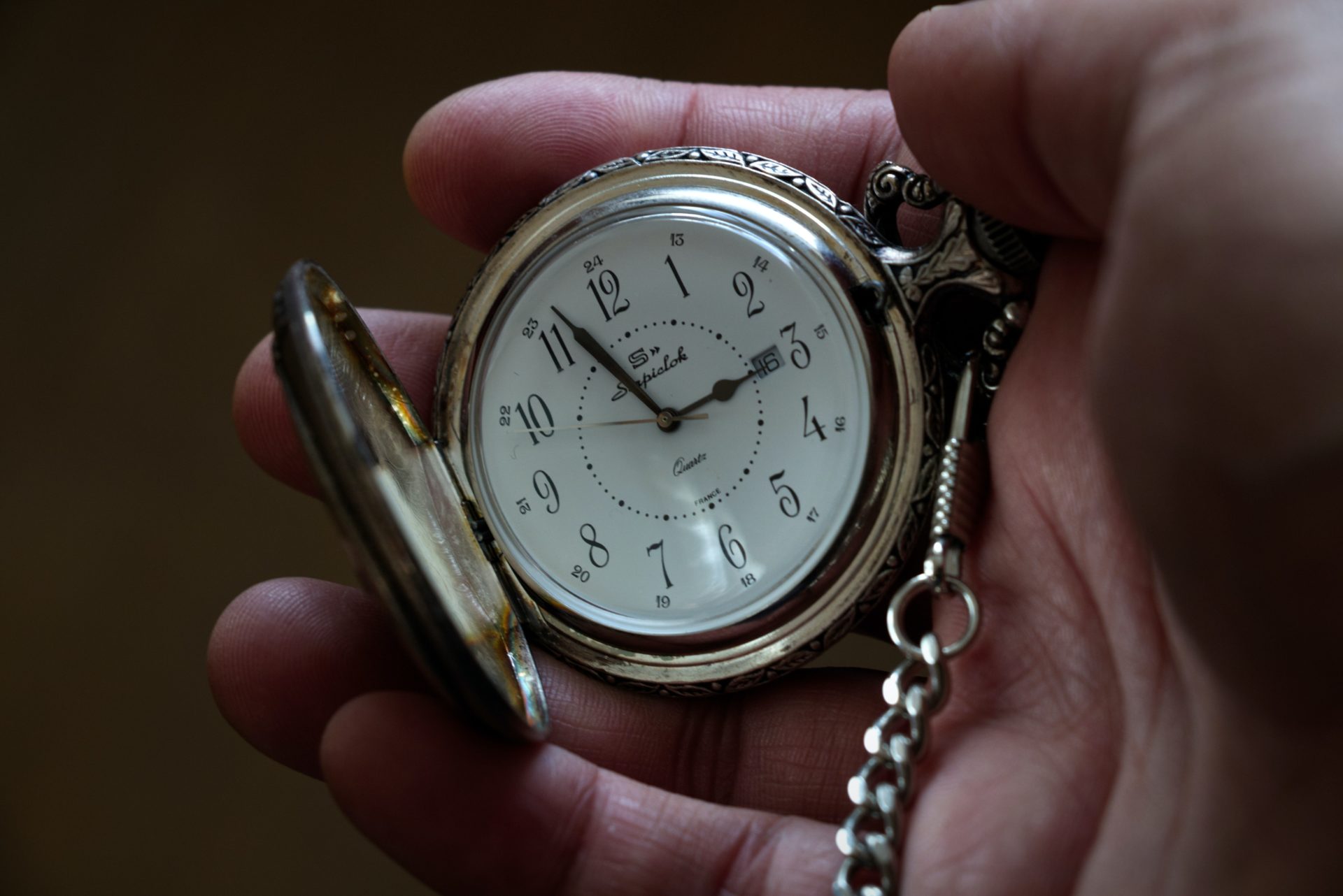 man holding a pocket watch